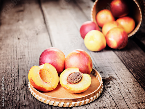 Fresh ripe nectarine peach fruit, crop rustic background
