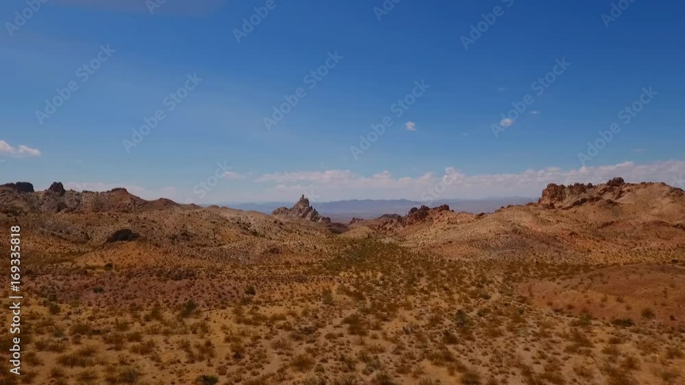 Aerial view of a distant rock pinnacle and a barren desert landscape Aerial view of a distant rock pinnacle and a barren desert landscape