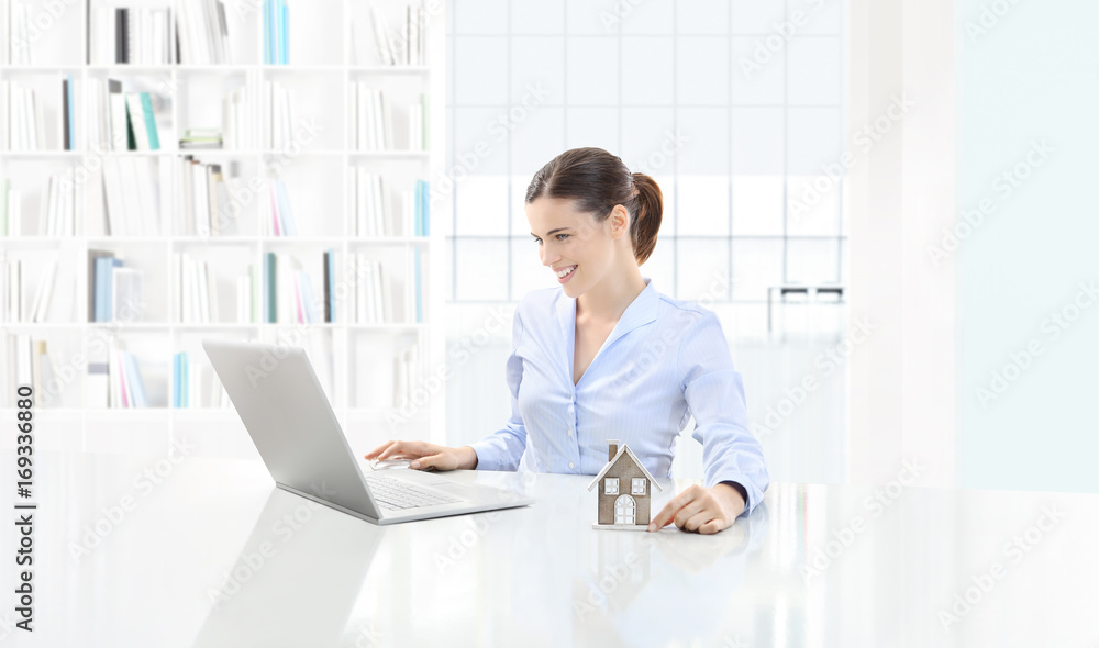 home concept smiling woman use the computer and showing house model, real estate and design home concept smiling woman use the computer and showing house model, real estate and design