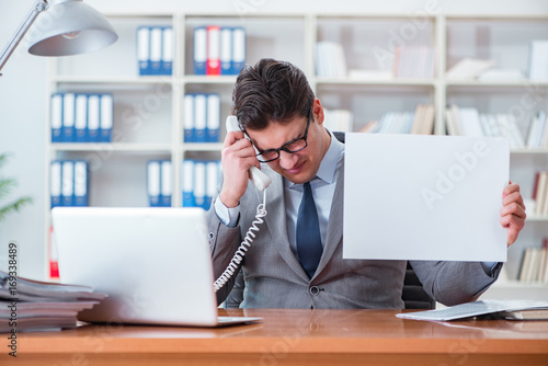 Businessman in office holding a blank message board