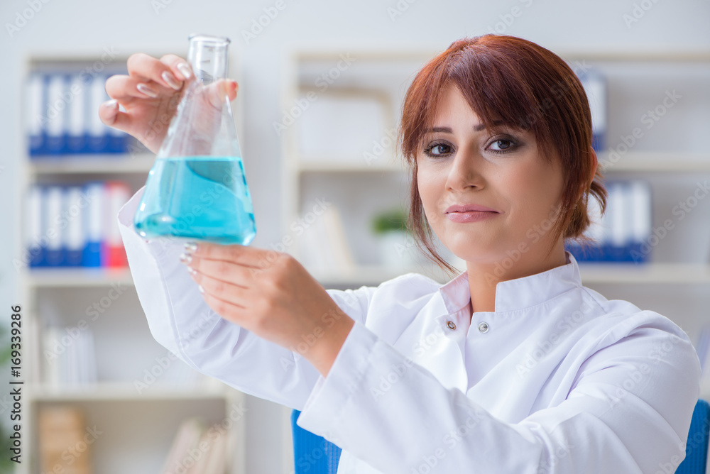 Female scientist researcher conducting an experiment in a labora Female scientist researcher conducting an experiment in a labora