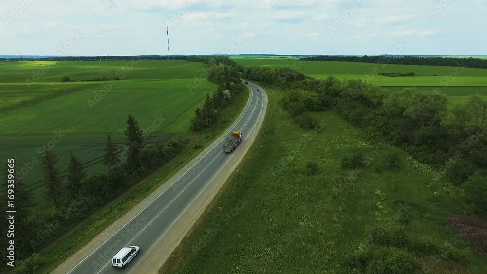 Amazing aerial view of road, cars, wheatfields and meadow Amazing aerial view of road, cars, wheatfields and meadow