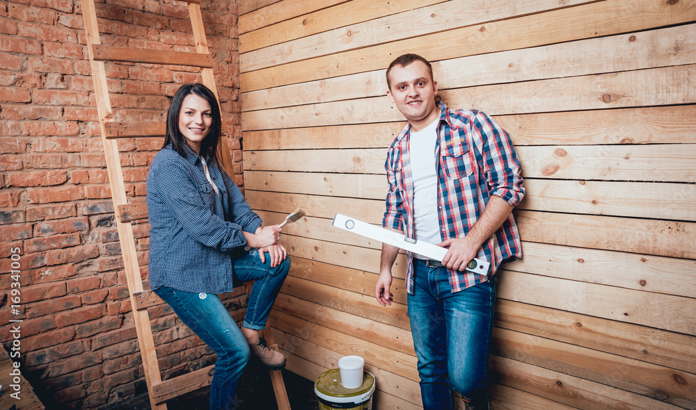 Happy couple making repairs to their home. Happy couple making repairs to their home.