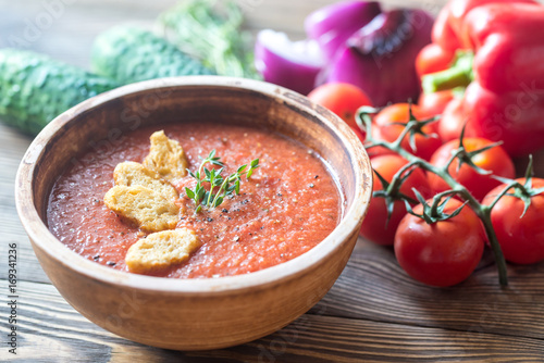 Bild auf Leinwand Bowl of gazpacho on the wooden table