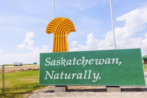Welcome to Saskatchewan - sign and flags photo