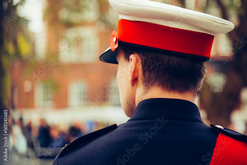 A telephoto shot of a soldier looking at blurred crowds during Remembrance Day