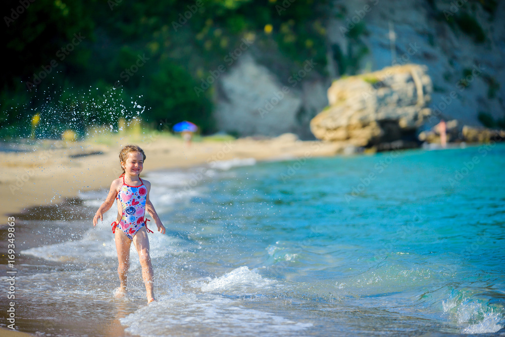 beautiful little girl, plays in the seashore beautiful little girl, plays in the seashore