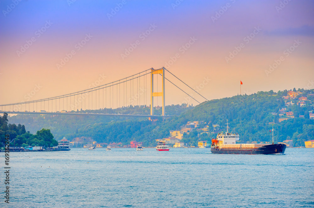 set of the ships passes across the canal Bosphorus, on a background the bridge through the passage, Istanbul