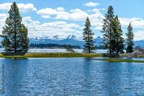Yellowstone Lake - A spring view of Yellowstone Lake with snow-capped mountain range in the background, Yellowstone National Park, Wyoming, USA.