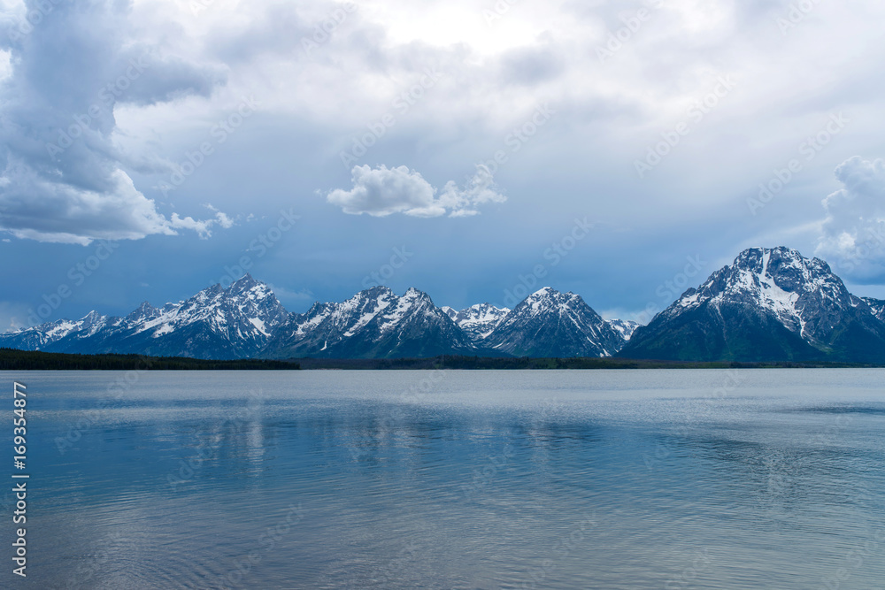 Stormy Mountain Lake - Spring afternoon storm clouds moving over Jackson Lake, with Teton Range rising in the background, Grand Teton National Park, Wyoming, USA. 