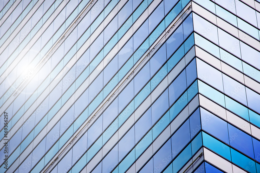 Blue sky and clouds reflecting in windows of modern office building Blue sky and clouds reflecting in windows of modern office building