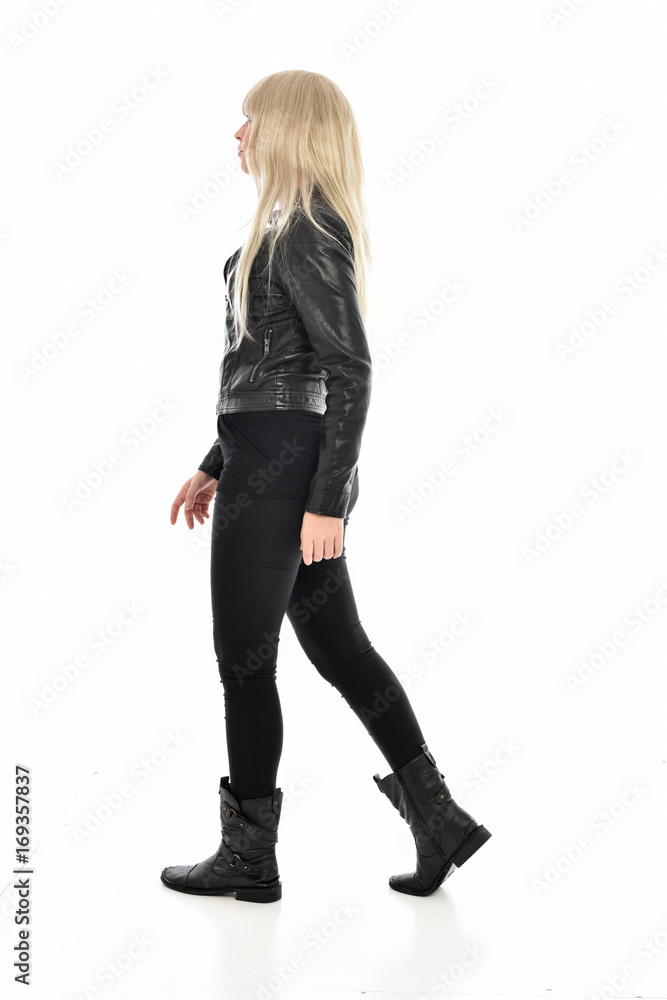 full length portrait of blonde girl wearing black leather outfit, standing pose on white background. full length portrait of blonde girl wearing black leather outfit, standing pose on white background.