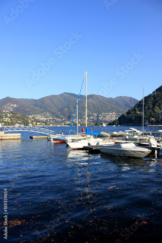 Boats along the coast in Lenno, Como lake, Italy. Beautiful touristic place