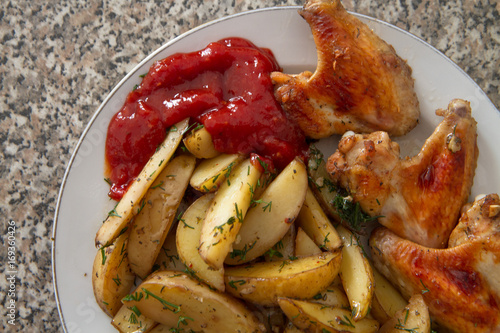 Chicken wings and young potatos II photo