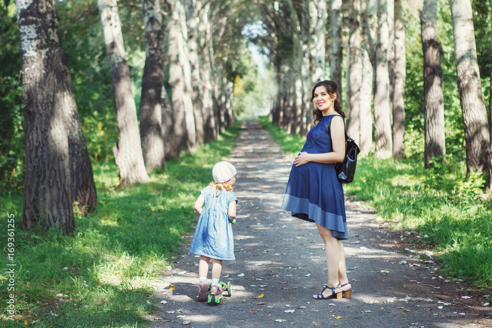 Fototapeta premium Asian pregnant woman with daughters