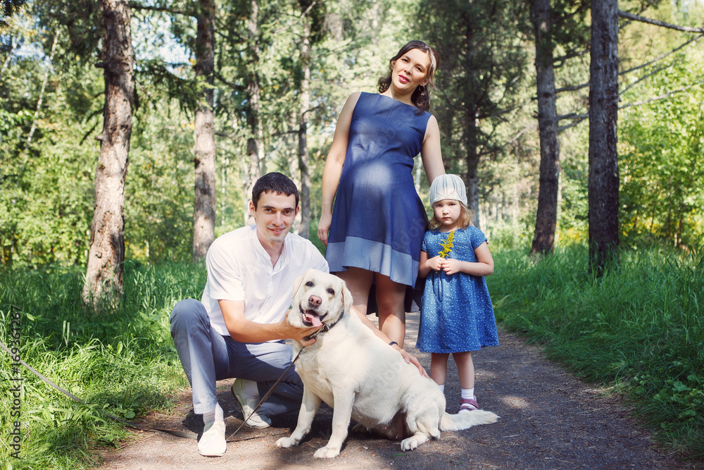 Happy family with dog walking in the Park Happy family with dog walking in the Park