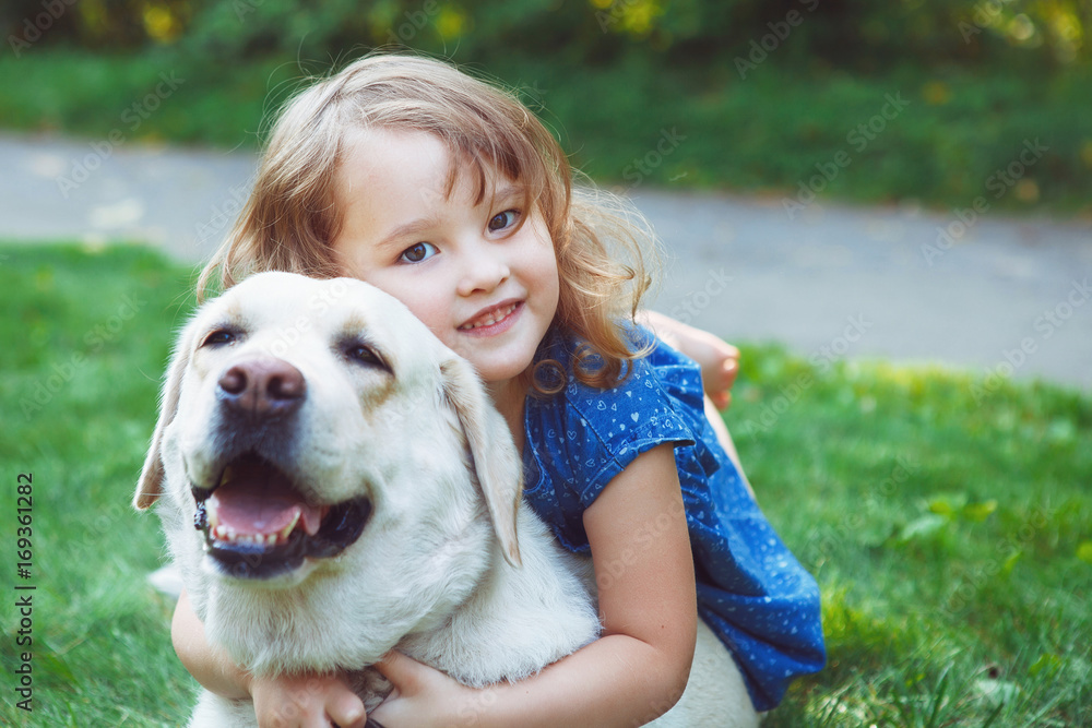 Little girl hugging a big dog Little girl hugging a big dog