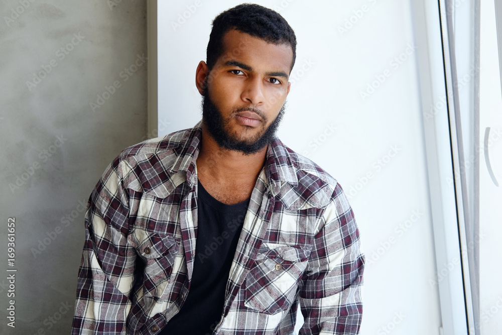 Portrait of Arabic hipster male in a fleece shirt. Stock Photo | Adobe Stock
