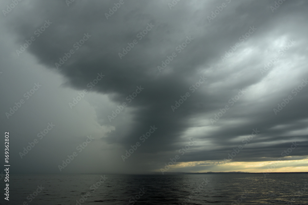 Dunkle Wolken über einem See in der Abenddämmerung Dunkle Wolken über einem See in der Abenddämmerung