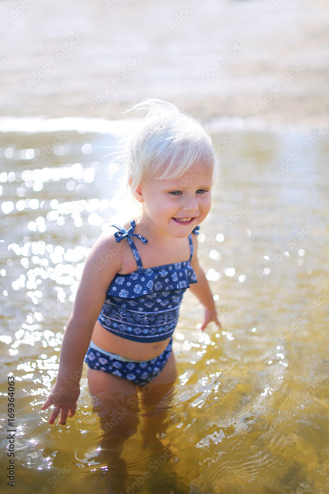 Happy Little Toddler Child Swimming in Lake on Summer Day Happy Little Toddler Child Swimming in Lake on Summer Day