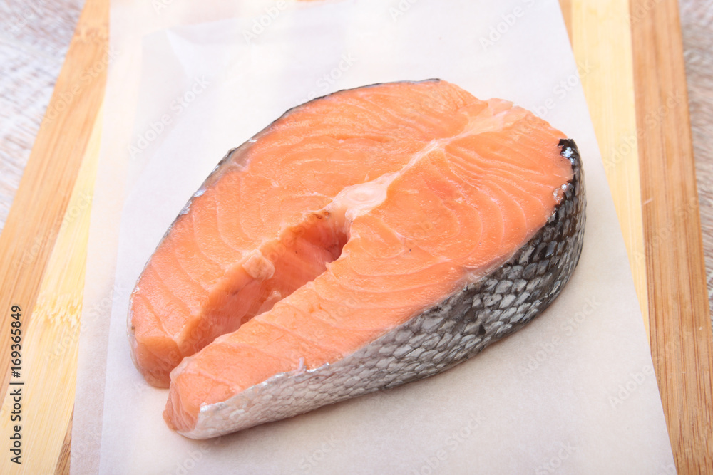 fresh raw salmon with spices on wooden cutting board. ready for cookin fresh raw salmon with spices on wooden cutting board. ready for cookin