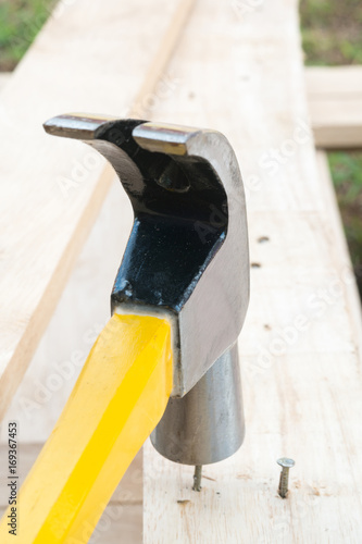 Hammer and Nail on wood.