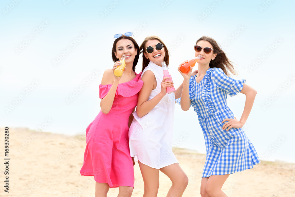 Beautiful young women with alcoholic drinks at sea resort Beautiful young women with alcoholic drinks at sea resort