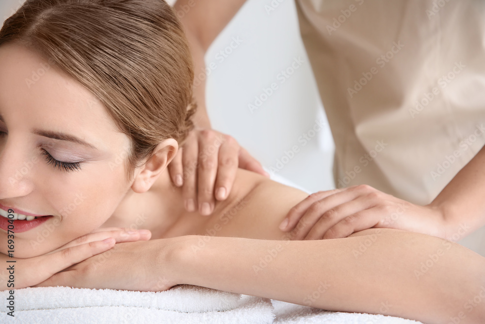 Young beautiful woman having massage in spa salon