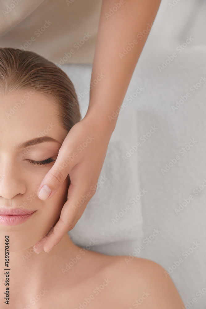 Young woman enjoying of facial massage in spa salon Young woman enjoying of facial massage in spa salon
