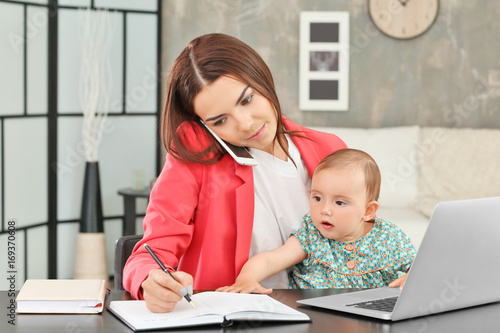 Young mother holding baby w...