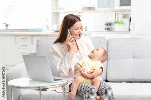 Young mother holding baby w...