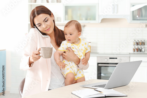 Young mother holding baby w...