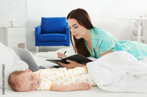 Young mother working near s...