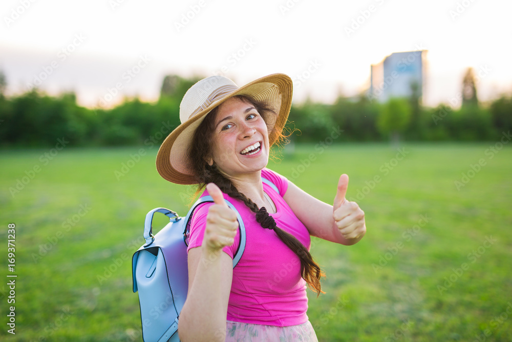 portrait on cute funny laughing or surprised woman with backpack and hat