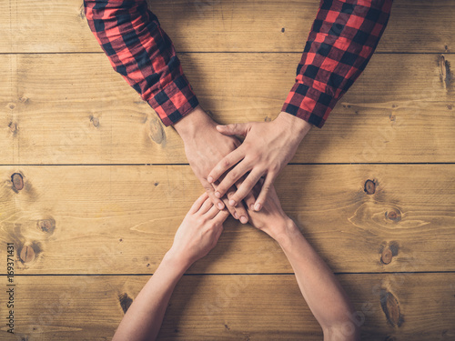 Over view of man and woman holding hands at table