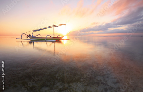 morning sun in Bali, Indonesia. Traditional fishing boats at Sanur beach, Bali, Indonesia.