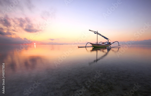 morning sun in Bali, Indonesia. Traditional fishing boats at Sanur beach, Bali, Indonesia.