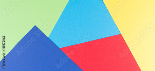 Color papers geometry flat composition background with yellow, green, red and blue tones