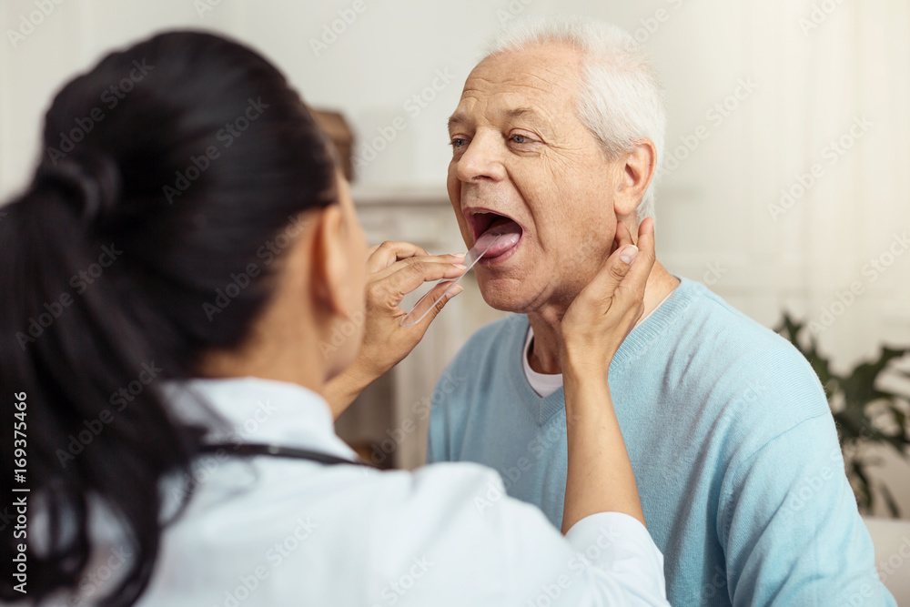 Fototapeta premium Skillful smart doctor checking her patient