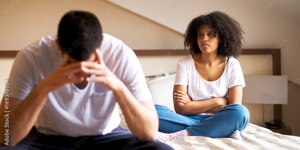 Couple is having a problem in a relationship, and they sit on the bed. Couple is having a problem in a relationship, and they sit on the bed.