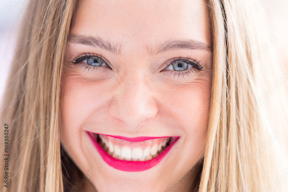 Happy young girl outdoors, front portrait photo with defocused copy space background Happy young girl outdoors, front portrait photo with defocused copy space background