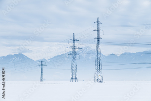 Electric pylons in the snow field