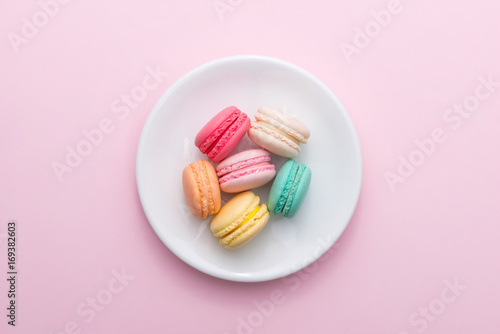 Colorful pastel cake macaron or macaroon on plate. photo