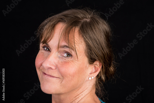 portrait of candid attractive mid-aged caucasian female adult - studio shot in front of dark background
