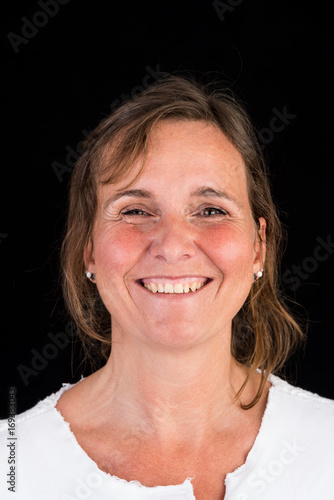 portrait of candid attractive mid-aged caucasian female adult - studio shot in front of dark background