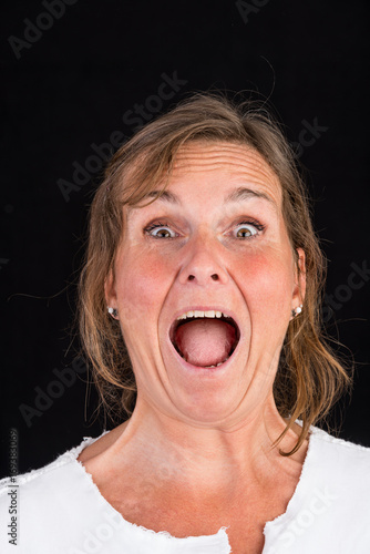 portrait of candid attractive mid-aged caucasian female adult - studio shot in front of dark background