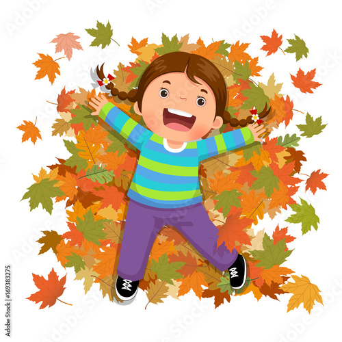 Cute girl playing with falling leaves