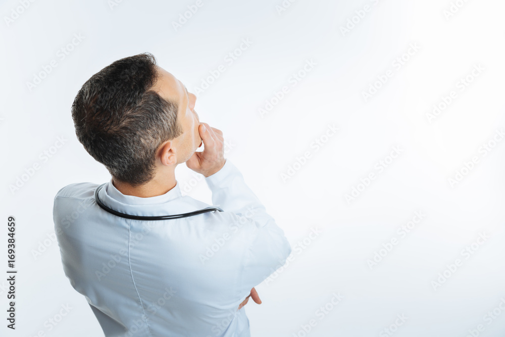 Top view of thoughtful medical worker thinking Top view of thoughtful medical worker thinking