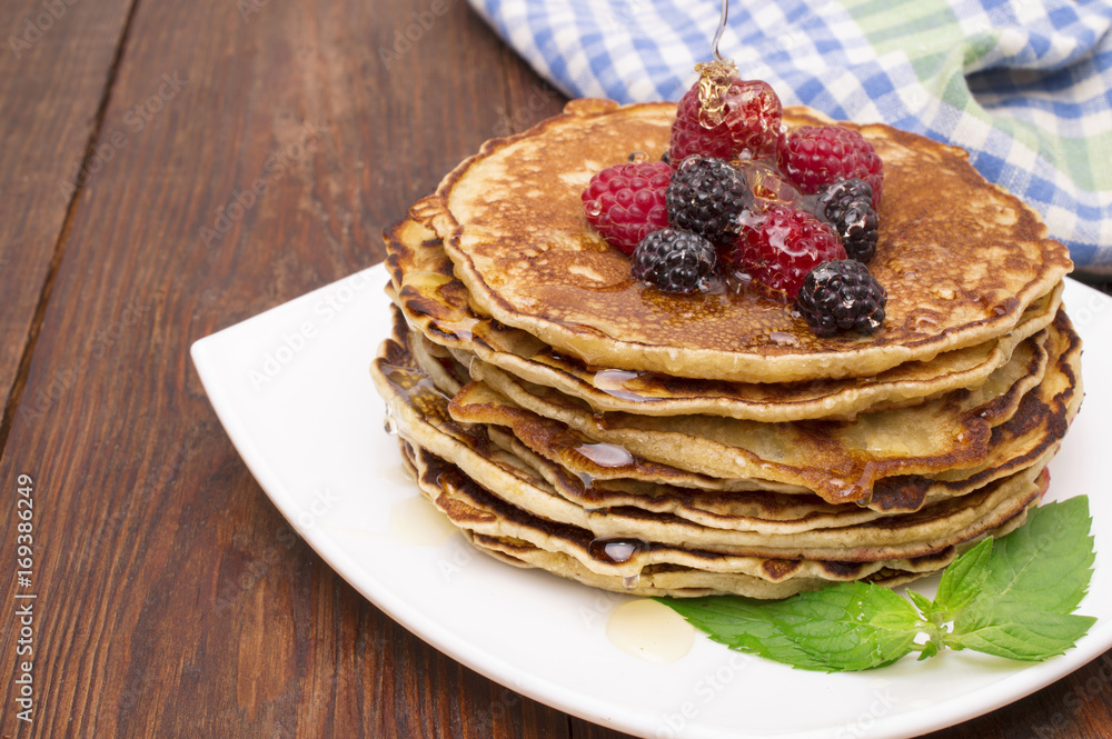 Delicious pancakes with berries and maple syrup