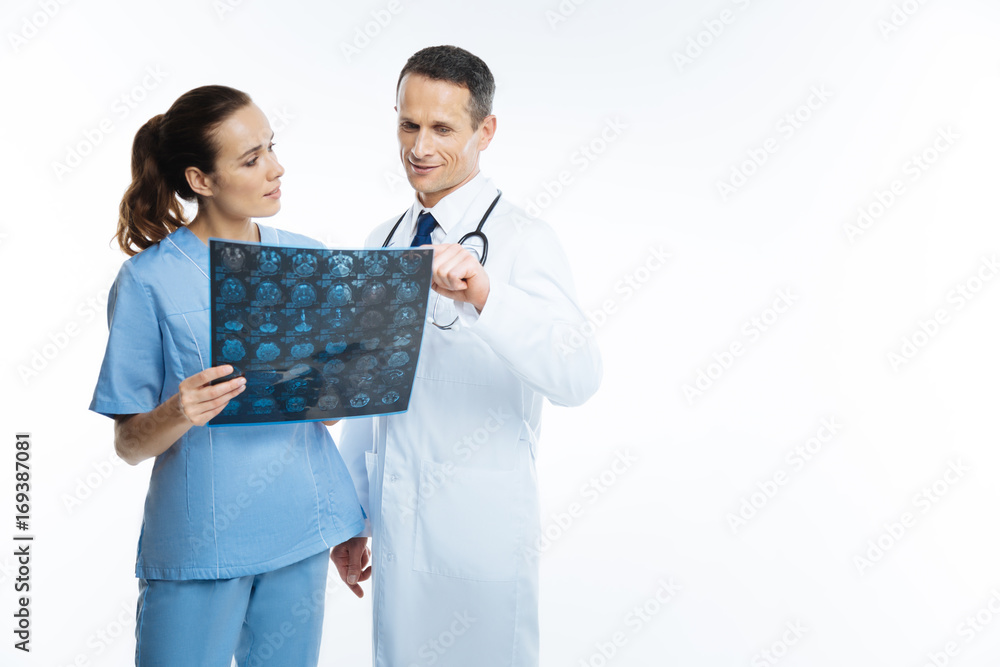 Medical colleagues counseling over mri scan picture Medical colleagues counseling over mri scan picture